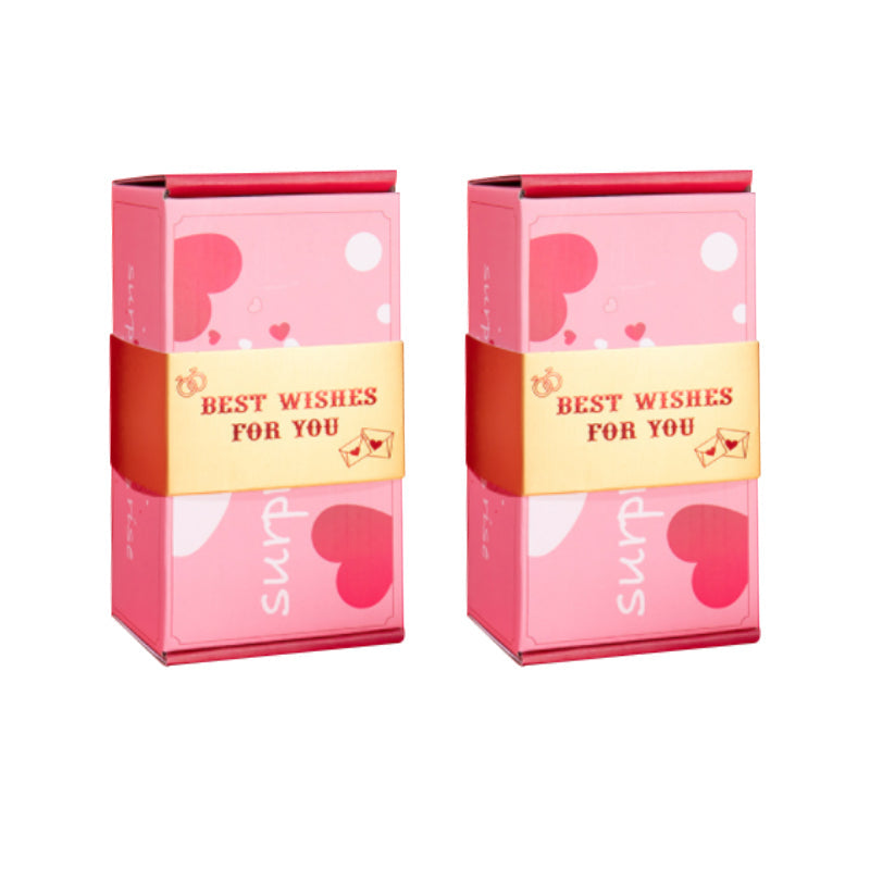 "Iloinen yllätyslahjapakkaus paperista, avautuva lahja, vaaleanpunaiset ja keltaiset värit, sisältää rahaa ja siunauspapereit