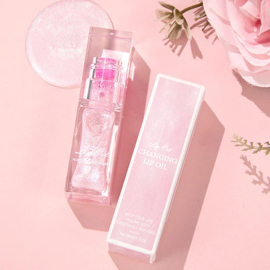 "Naisten huuliöljy, väriä muuttava, kosteuttava luonnonöljyillä, vaaleanpunainen sävy, kiiltävä ja pehmeä ilme."